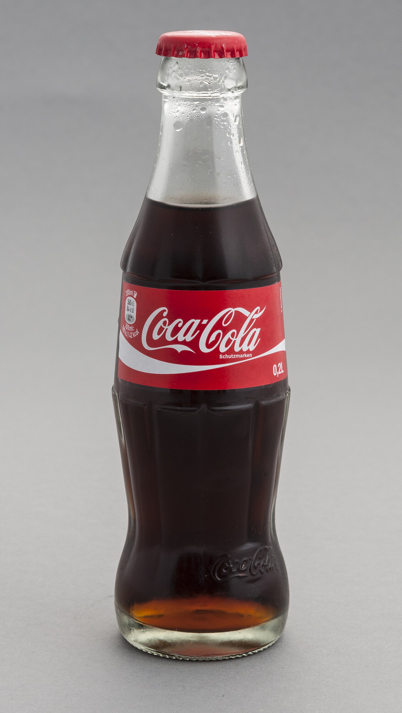 A classic contour Coca-Cola glass bottle