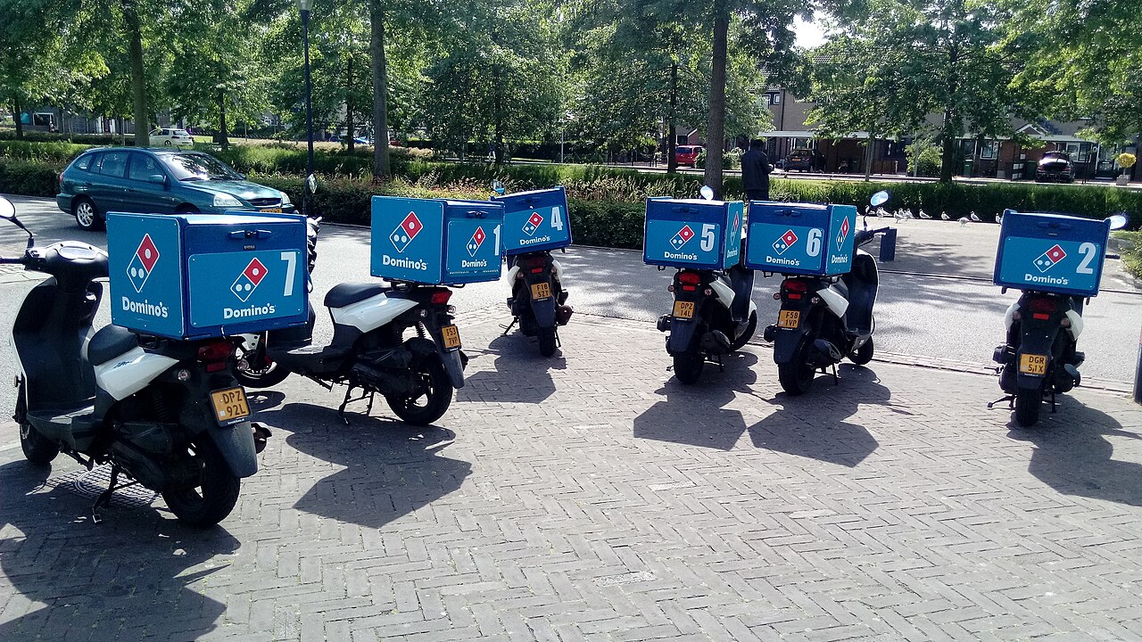 Row of Domino's Pizza delivery scooters