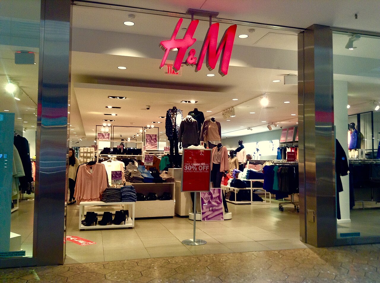 The entrance of an H&M store with its red logo