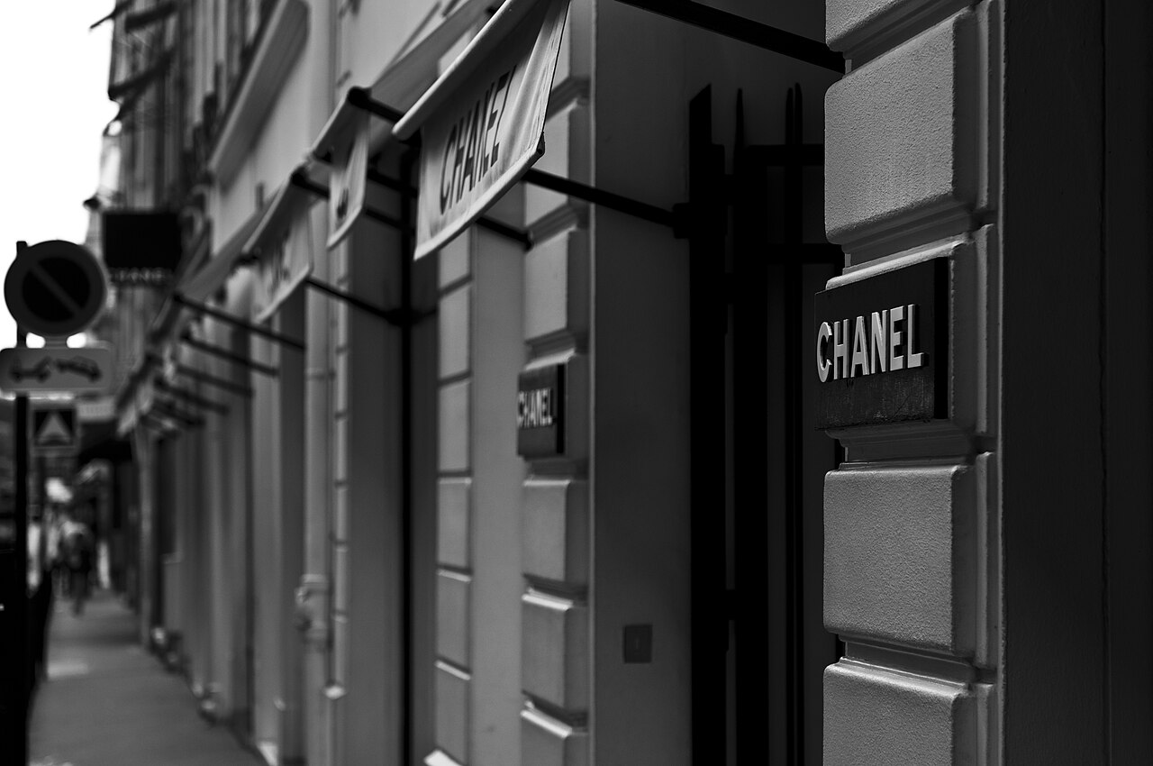 Black and white photograph of Chanel signage outside the Rue Cambon boutique in Paris.