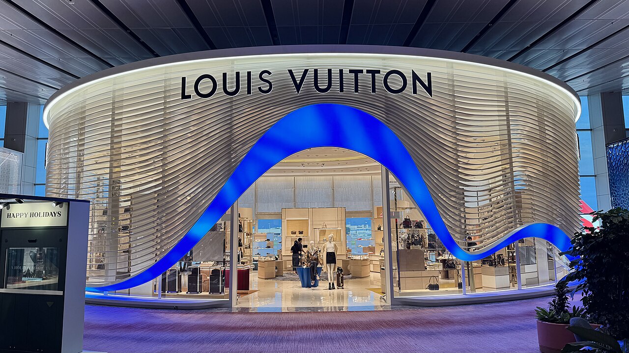 Louis Vuitton boutique at Changi Airport Terminal 1 in Singapore, with a sweeping blue and gold facade.