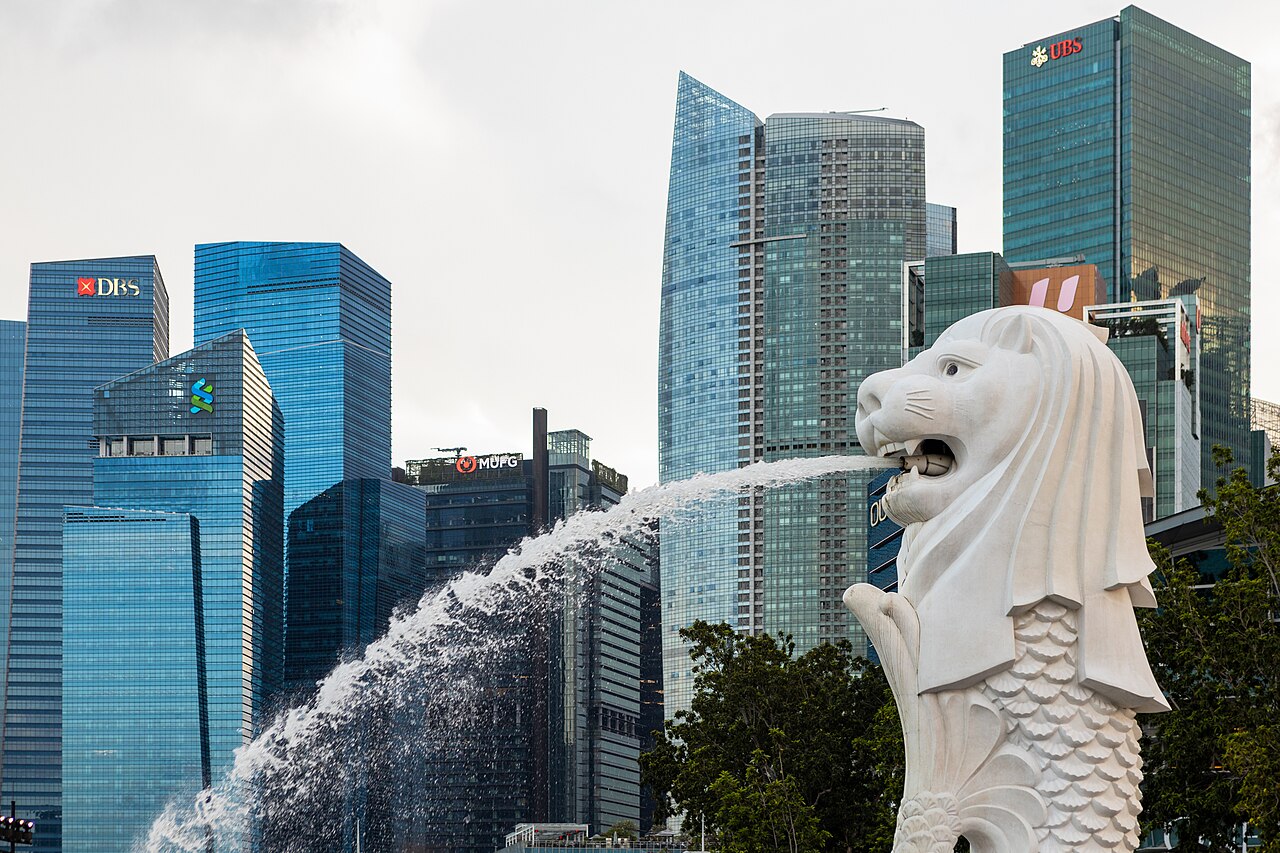 The Merlion statue spouting water in front of Singapore's Marina Bay towers