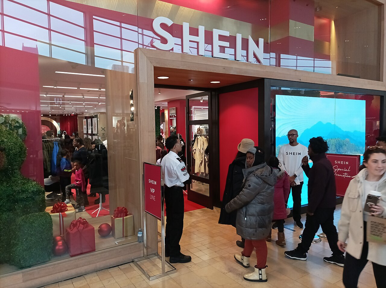 Entrance of a Shein pop-up store with the red Shein name above the door