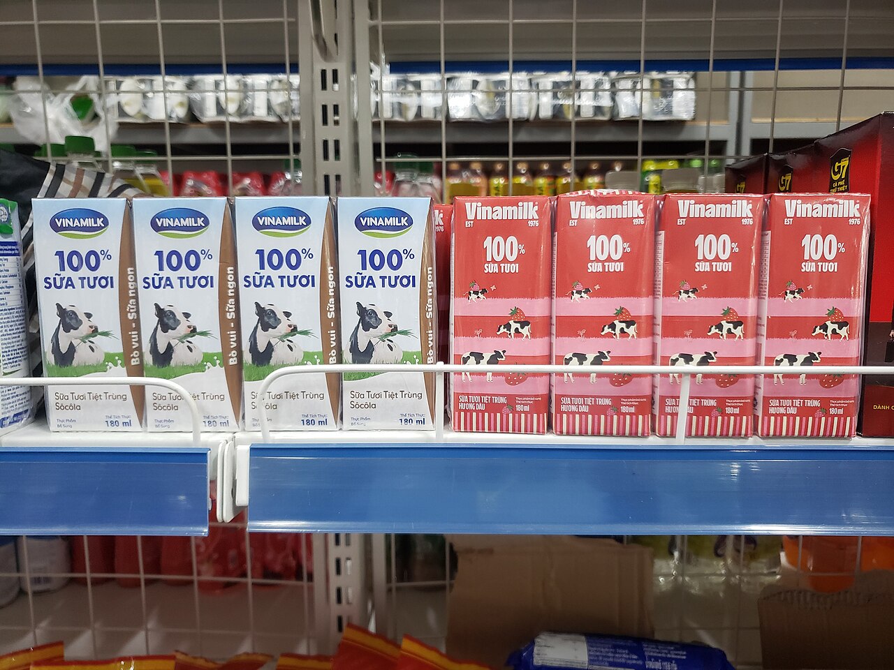 Vinamilk cartons in old and 2023 branding on a shelf