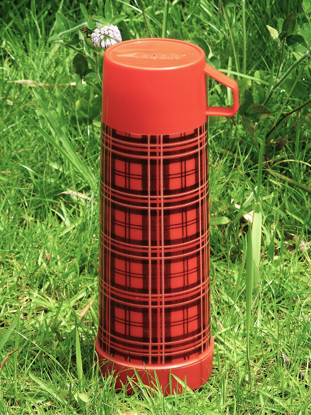 A vintage red tartan Aladdin vacuum flask